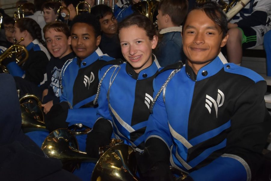 De Jesus (right) with the Marching Knights during a Friday night football game.