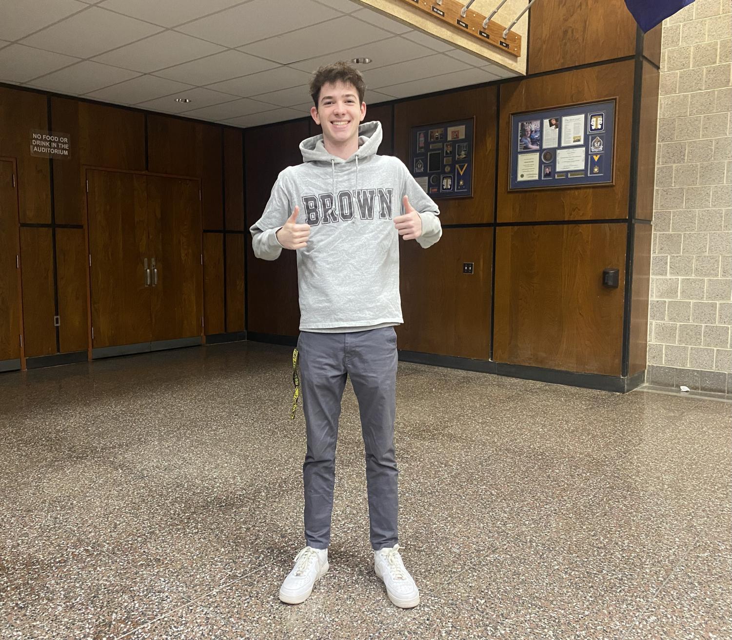 Jack Bachman poses wearing his new Brown University merch.