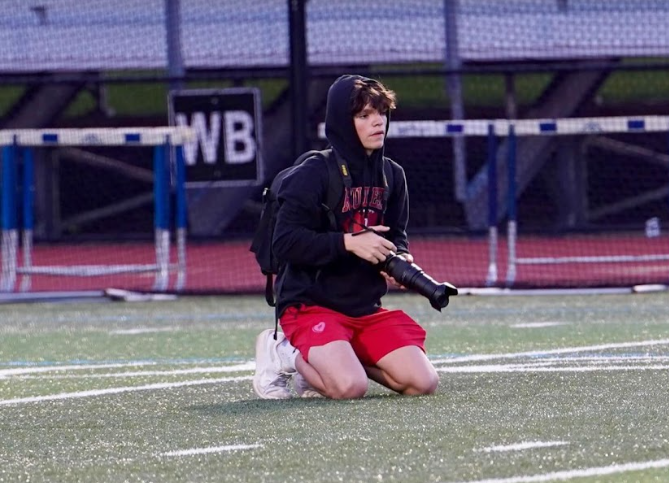 Joe Jones capturing a game from the sidelines