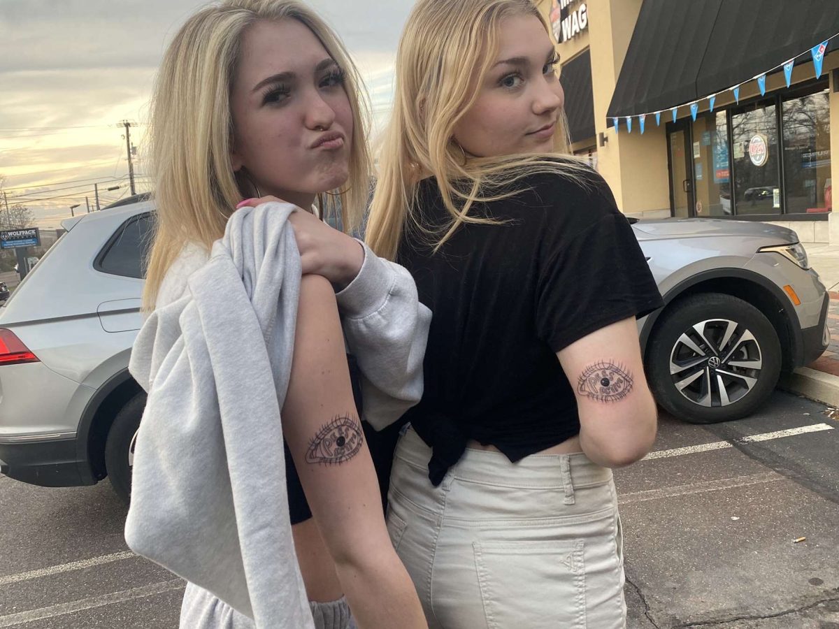 Renny Mulford and her friend, tatted up, with their matching 'Perspective' tattoos. 