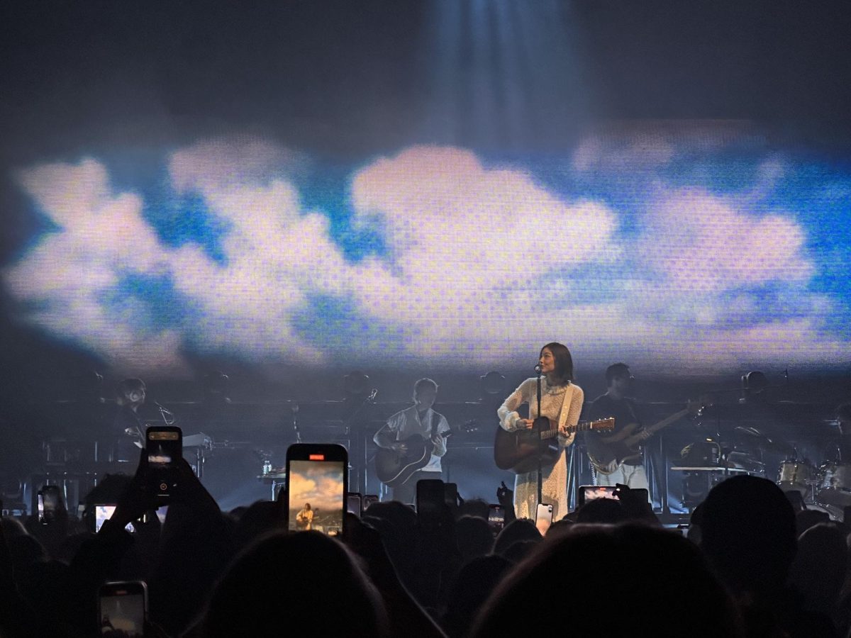 Abrams playing her guitar as she sings her hit single "Risk" 