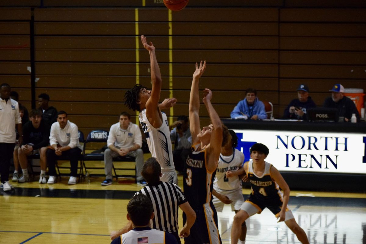 North Penn's Gabe Altemus tips off against Michael Malton (3) in their game against Wissahickon.