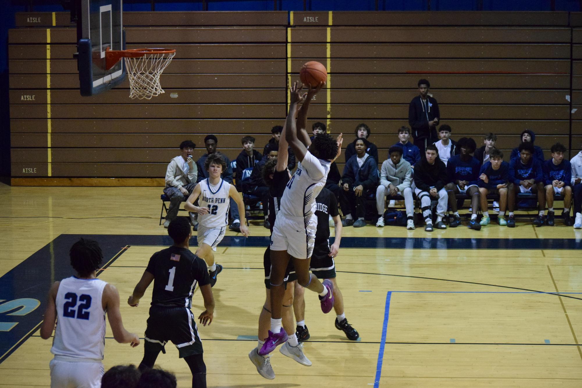 Aiden Atkinson shoots a contested fade away jumper over a Pennridge defender.