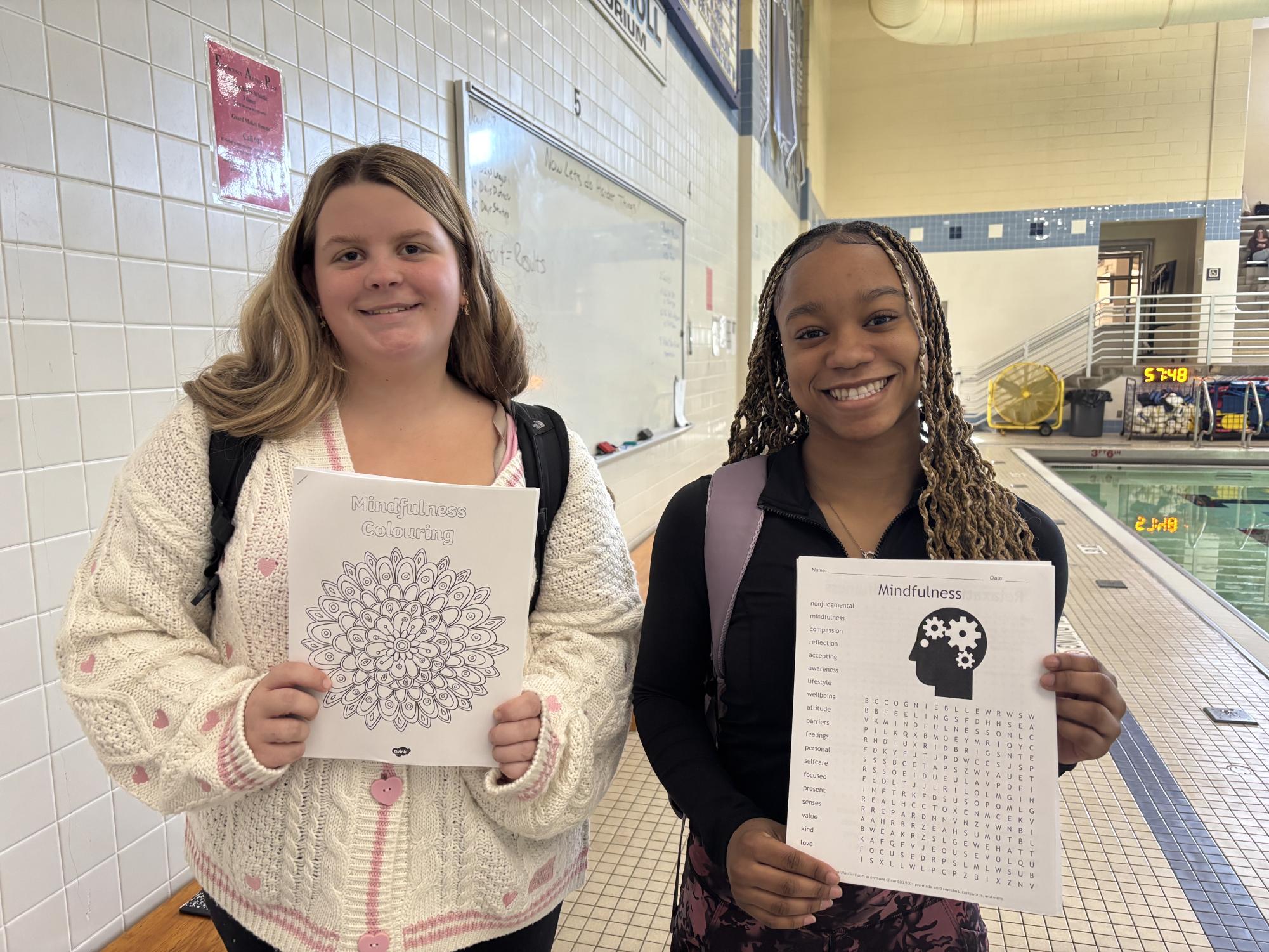  Mindfulness and Movement students, Addison McCoy and Deja Dublin, pose with their work for class. 