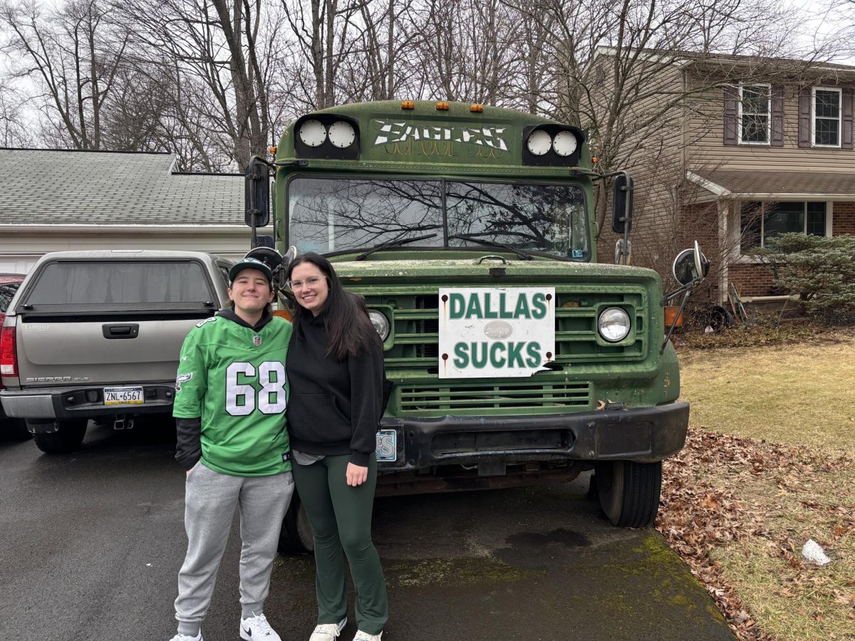 Megan (left) and Madison (right) Curry stand in front of their family’s famous Eagles themed bus