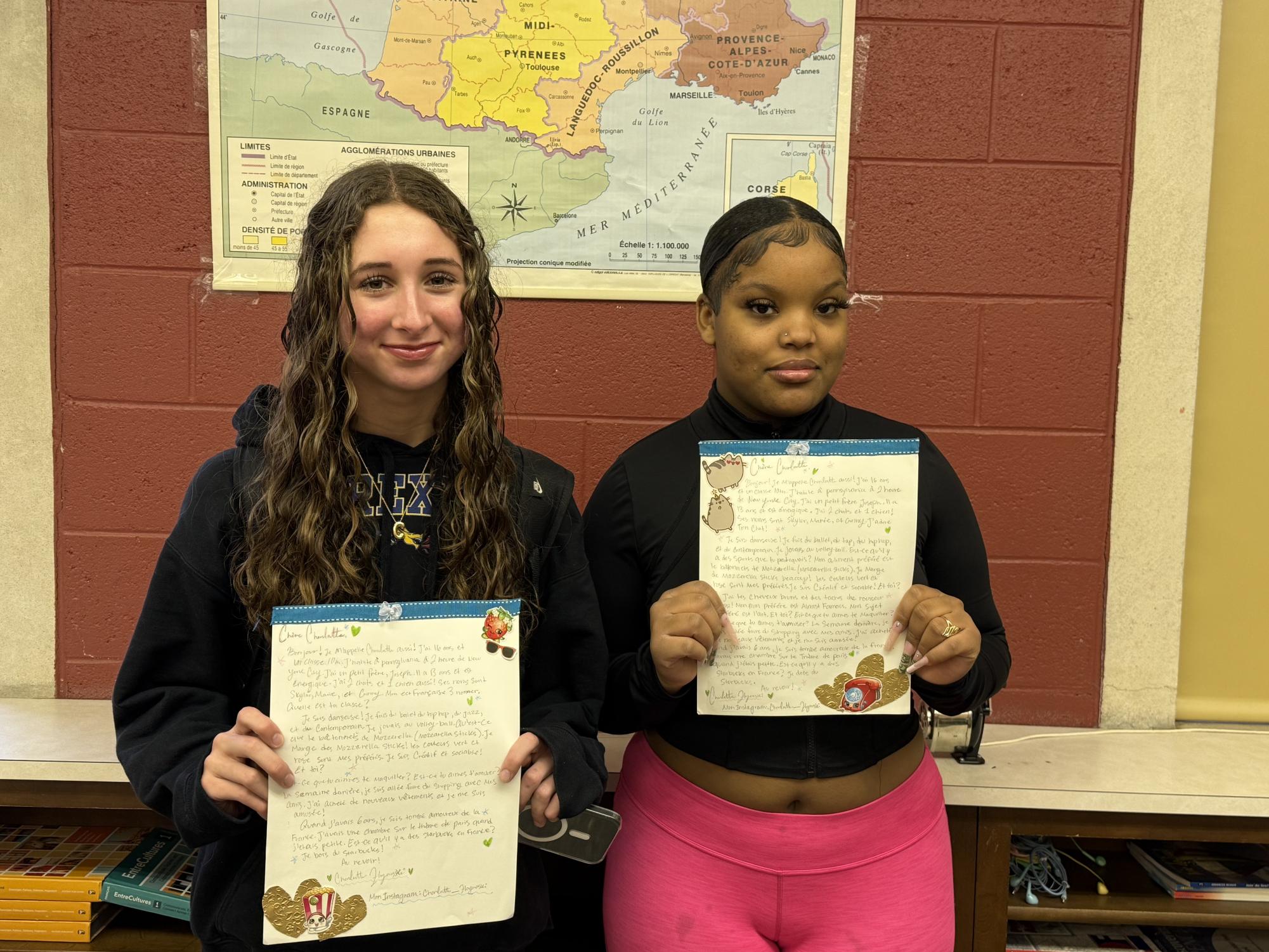 French students holding up their letters that will be sent off to France in a few days