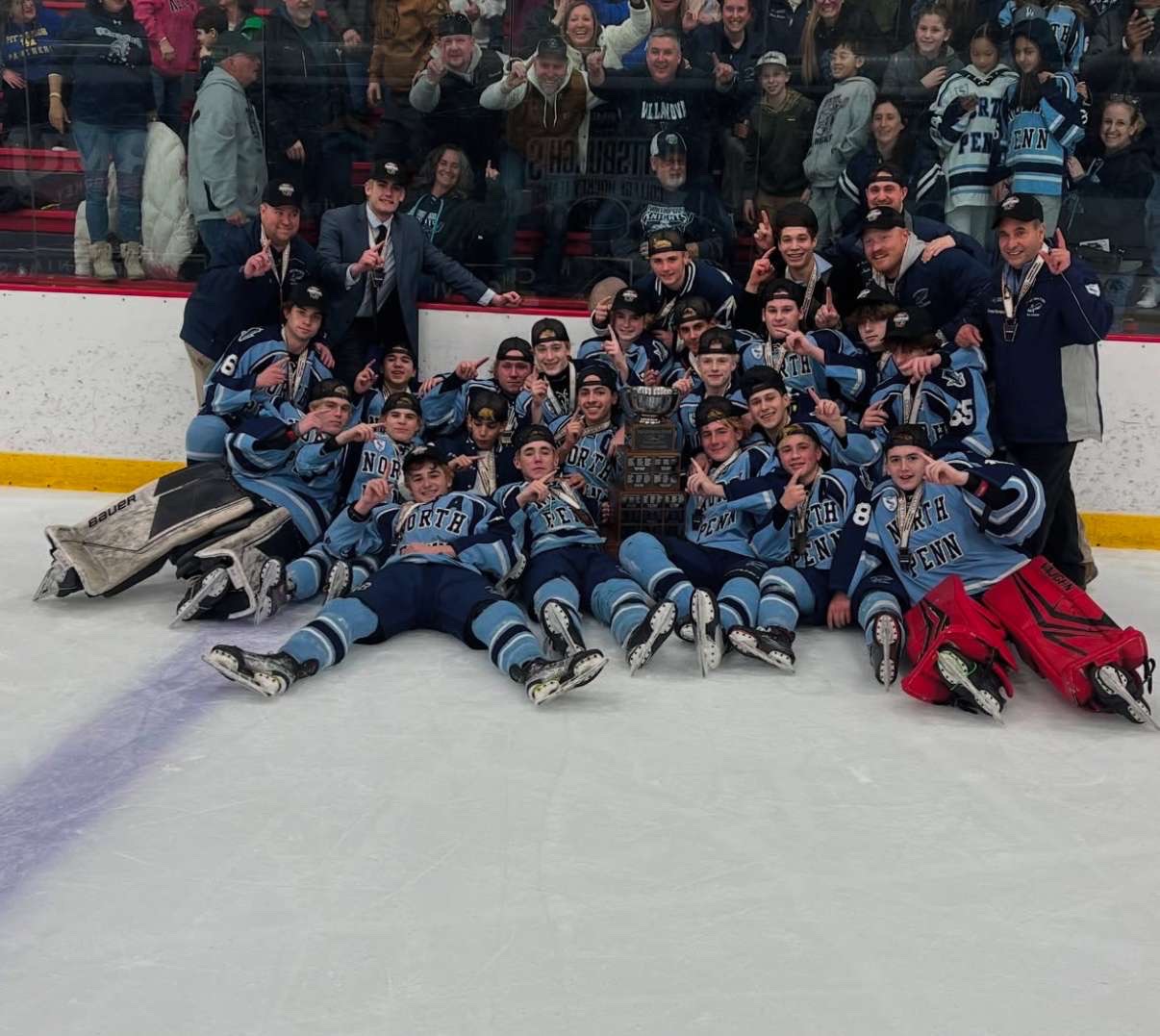 The North Penn Knights celebrate on the ice as the Pennsylvania 2A state champions.
