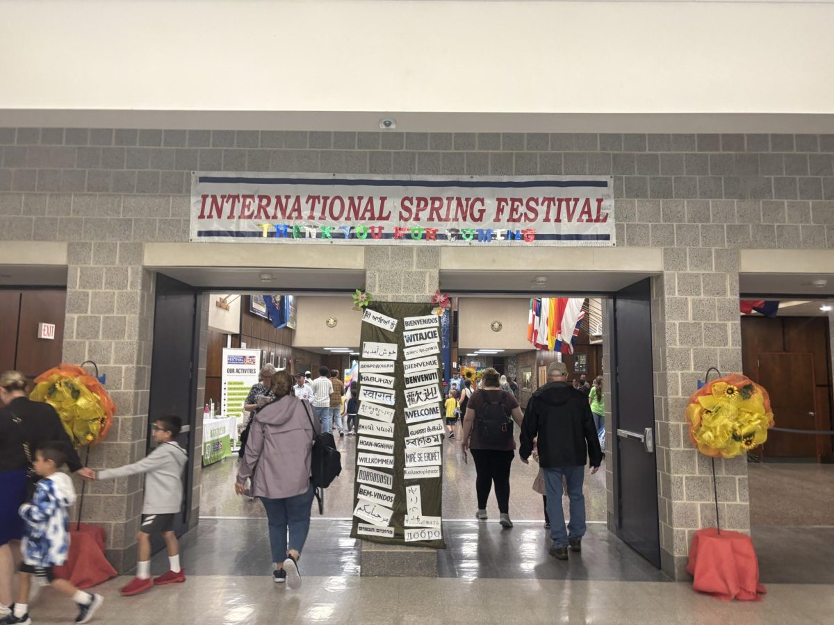 The sign inside the building displayed the event, "International Spring Festival", marking the entrance to a day filled with cultural celebration.